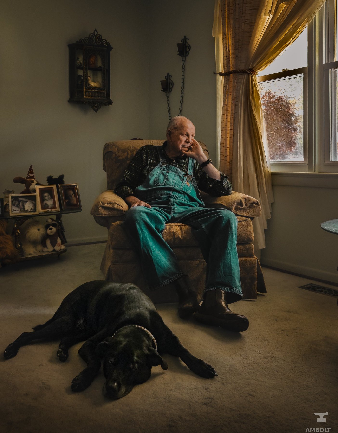 Environmental portrait of a man and his dog at home
