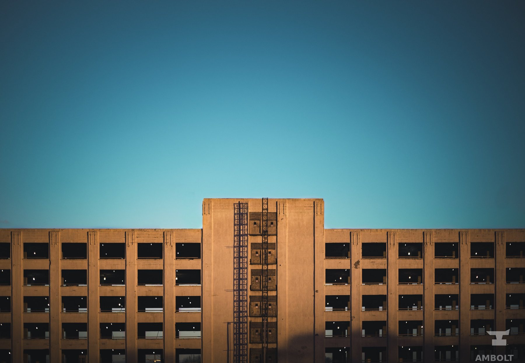 Brutalist tower against a teal sky